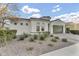 Charming single-story home featuring desert landscaping, a two-car garage, and a barrel-tile roof on a sunny day at 10719 E Simone Ave, Mesa, AZ 85212