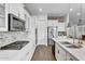 Bright kitchen featuring white cabinets, stainless steel appliances, and a white countertop island at 10719 E Simone Ave, Mesa, AZ 85212