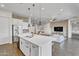 Bright kitchen with white cabinets, stainless steel appliances, large island, and open-concept layout at 10719 E Simone Ave, Mesa, AZ 85212