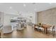 Open-concept living space with wood floors, a large sectional, dining area, and a brick accent wall at 10719 E Simone Ave, Mesa, AZ 85212