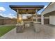 Outdoor kitchen with stone accents, built-in grill, and covered area perfect for entertaining at 10719 E Simone Ave, Mesa, AZ 85212