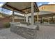 Outdoor kitchen featuring a built-in grill, counter space, and shaded seating area at 10719 E Simone Ave, Mesa, AZ 85212