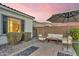 A comfortable patio area with a shade umbrella and modern outdoor seating at 10719 E Simone Ave, Mesa, AZ 85212