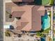 Aerial view of a house with a tiled roof, pool, and well-maintained yard in a residential area at 10722 E Keats Ave, Mesa, AZ 85209