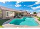 Lush backyard with a sparkling pool, covered patio, and well-manicured landscaping at 10722 E Keats Ave, Mesa, AZ 85209