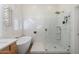 Bright bathroom features a soaking tub with a shower head and a glass enclosed walk-in shower with gold fixtures at 10722 E Keats Ave, Mesa, AZ 85209