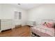 This bedroom offers wood floors and a shuttered window, creating a cozy and inviting atmosphere at 10722 E Keats Ave, Mesa, AZ 85209