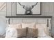 Tastefully decorated bedroom featuring a cozy bed with plush pillows and an eye-catching portrait above the headboard at 10722 E Keats Ave, Mesa, AZ 85209