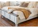 Comfortable bedroom showcasing a cozy bed with a plush blanket, complemented by sleek wood floors at 10722 E Keats Ave, Mesa, AZ 85209