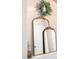 Charming interior accent mirrors, paired with subtle decor and a wreath, add character to the entryway at 10722 E Keats Ave, Mesa, AZ 85209