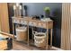 An elegant entryway features a wood table, decor, and storage baskets, creating a warm and inviting space at 10722 E Keats Ave, Mesa, AZ 85209
