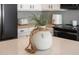 Close up of a kitchen countertop with wood beaded decor and white cabinets in the background at 10722 E Keats Ave, Mesa, AZ 85209