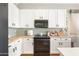 Modern kitchen with white cabinets, stainless steel appliances, and ample counter space at 10722 E Keats Ave, Mesa, AZ 85209