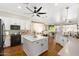 Bright, open kitchen boasts white cabinetry, modern appliances, and a central island, perfect for entertaining at 10722 E Keats Ave, Mesa, AZ 85209