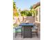 Outdoor patio table set with cushioned chairs and greenery in the background at 10722 E Keats Ave, Mesa, AZ 85209