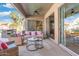 Cozy covered patio with comfortable seating, ceiling fans, and sliding glass doors at 10722 E Keats Ave, Mesa, AZ 85209