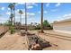 Landscaped backyard with palm trees, garden bed and sand at 11420 N 50Th St, Scottsdale, AZ 85254