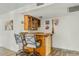 Entertaining bar area features two stools and built-in glassware storage cabinet at 11420 N 50Th St, Scottsdale, AZ 85254