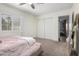 This bedroom features a cozy bed, a mirror and closet space at 11420 N 50Th St, Scottsdale, AZ 85254