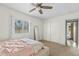 Bright bedroom with a ceiling fan, spacious closet, and a sun-filled window at 11420 N 50Th St, Scottsdale, AZ 85254