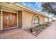 Inviting brick home featuring a double-door entrance, arched window and landscaped garden at 11420 N 50Th St, Scottsdale, AZ 85254