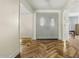 Inviting foyer with herringbone wood floors and a gray double-door entrance to the home at 11420 N 50Th St, Scottsdale, AZ 85254