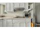 Modern kitchen boasts white cabinetry, countertops, and stainless steel appliances at 11420 N 50Th St, Scottsdale, AZ 85254