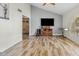 Open-concept living room with modern wood flooring, a vaulted ceiling, and recessed lighting at 11420 N 50Th St, Scottsdale, AZ 85254