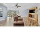 Open-concept living room featuring wood floors, a fireplace, built-in shelving, and seamless access to the dining area at 11420 N 50Th St, Scottsdale, AZ 85254
