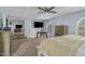 Spacious main bedroom featuring plush carpet, modern ceiling fan, and arched window with plantation shutters at 11420 N 50Th St, Scottsdale, AZ 85254