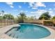 Sparkling backyard pool with a secure safety fence and surrounding patio area at 11420 N 50Th St, Scottsdale, AZ 85254