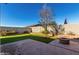 Brick patio and grassy yard featuring a fire pit and block wall at 11554 W Lone Tree Trl, Peoria, AZ 85383