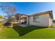 Grassy backyard featuring a trampoline and covered patio area at 11554 W Lone Tree Trl, Peoria, AZ 85383