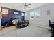 Cozy bedroom with a blue accent wall, carpet, and a window providing natural light at 11554 W Lone Tree Trl, Peoria, AZ 85383