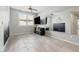 Neutral-toned bedroom with light tile floors, large windows, and modern ceiling fan at 11554 W Lone Tree Trl, Peoria, AZ 85383