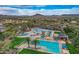 Great aerial view of a resort-style pool features a lap pool, a slide, and shaded seating at 11554 W Lone Tree Trl, Peoria, AZ 85383