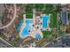 Aerial view of a resort-style pool with a splash pad, slide, and shade structures at 11554 W Lone Tree Trl, Peoria, AZ 85383