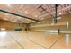 Spacious indoor gym with basketball court, bleachers, and high ceilings for various activities at 11554 W Lone Tree Trl, Peoria, AZ 85383