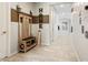 Bright entryway featuring tiled floors, decorative wall accents, and a wooden hall tree with storage at 11554 W Lone Tree Trl, Peoria, AZ 85383