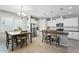A bright kitchen featuring white cabinets, stainless steel appliances, and a dining area with a wooden table at 11554 W Lone Tree Trl, Peoria, AZ 85383