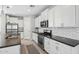 Modern kitchen with white cabinetry, sleek countertops, and stainless steel appliances at 11554 W Lone Tree Trl, Peoria, AZ 85383