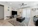 Comfortable living room with tile flooring, a ceiling fan, and a decorative rug at 11554 W Lone Tree Trl, Peoria, AZ 85383