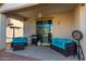 Covered patio area with seating, grill, and dartboard setup at 11554 W Lone Tree Trl, Peoria, AZ 85383