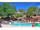 Outdoor pool with multiple water slides and lush landscaping, perfect for Gathering fun at 11554 W Lone Tree Trl, Peoria, AZ 85383