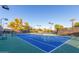 Outdoor tennis court with well maintained blue surface at 11554 W Lone Tree Trl, Peoria, AZ 85383