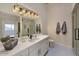 Elegant bathroom featuring a large mirror with decorative lighting and a glass-enclosed shower at 12225 E Cortez Dr, Scottsdale, AZ 85259