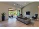 Spacious living room featuring a large sectional sofa, accent chairs, and expansive glass doors to the patio at 12225 E Cortez Dr, Scottsdale, AZ 85259