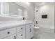 Modern bathroom features double sink vanity, matte black fixtures, and tiled shower with storage niche at 13012 S 218Th Ave, Buckeye, AZ 85326