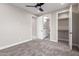 Cozy bedroom featuring plush carpeting, neutral walls, and ensuite bathroom and walk-in closet at 13012 S 218Th Ave, Buckeye, AZ 85326