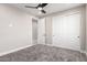 Bedroom featuring neutral walls, carpet floors, ceiling fan, and a sliding door closet at 13012 S 218Th Ave, Buckeye, AZ 85326